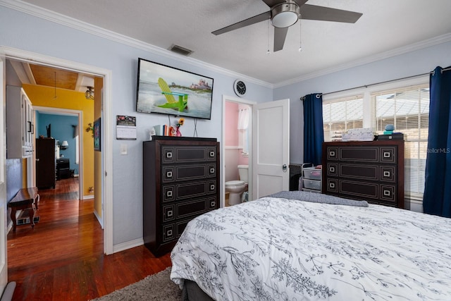 bedroom featuring connected bathroom, dark hardwood / wood-style floors, ceiling fan, and crown molding