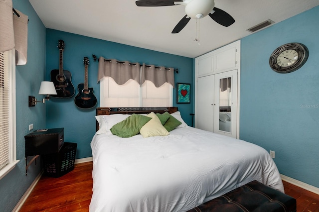 bedroom featuring ceiling fan and dark wood-type flooring