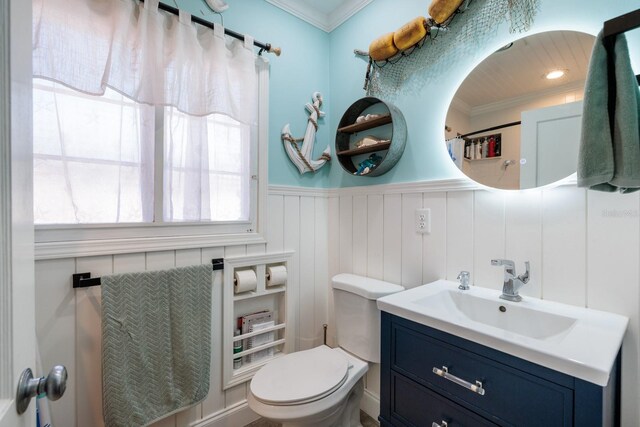 bathroom with vanity, ornamental molding, and toilet