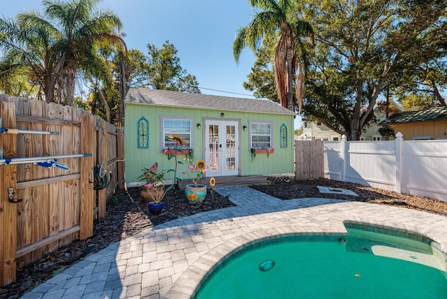 view of pool featuring an outbuilding and a patio