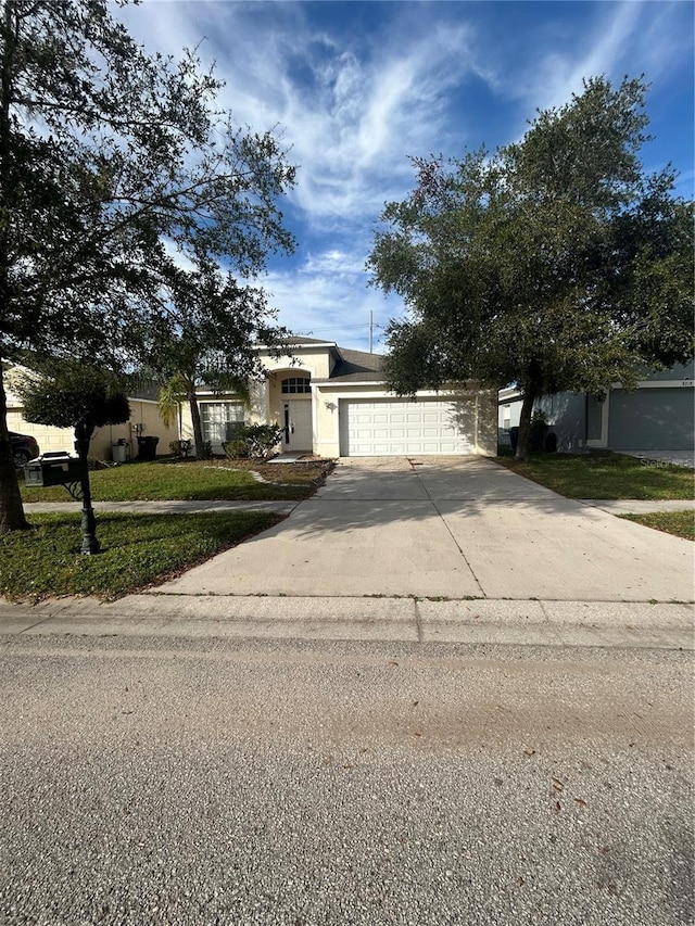 view of front of home with a front lawn and a garage