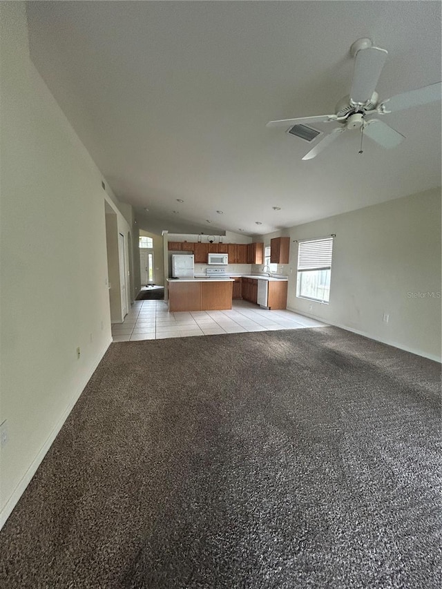 unfurnished living room with ceiling fan and light colored carpet