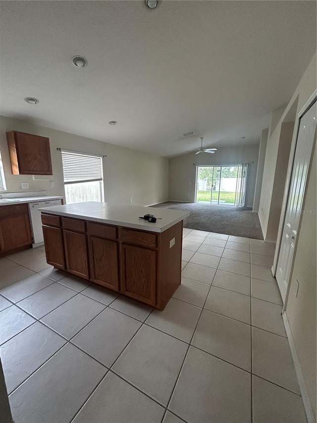 kitchen featuring dishwasher, ceiling fan, a center island, and light tile patterned floors