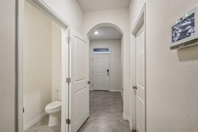 hallway featuring light tile patterned floors