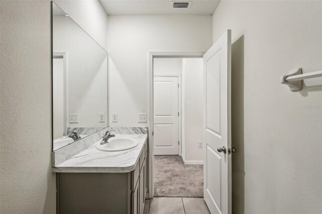 bathroom featuring tile patterned flooring and vanity