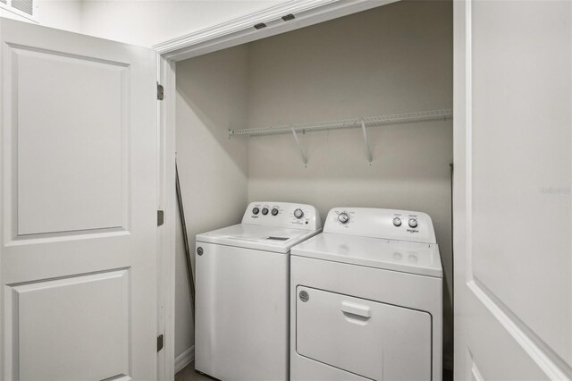 washroom with washing machine and clothes dryer