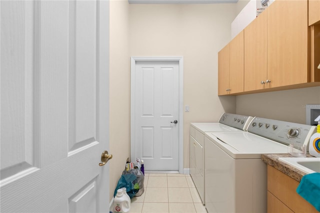 laundry area featuring light tile patterned floors, cabinets, and independent washer and dryer