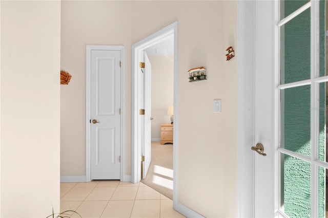 corridor featuring light tile patterned floors