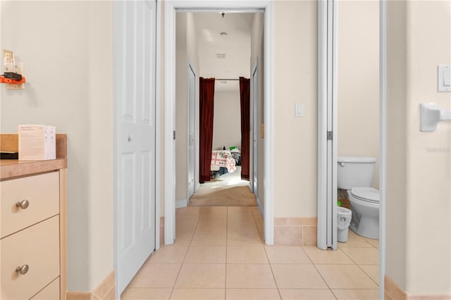 hall with light tile patterned floors