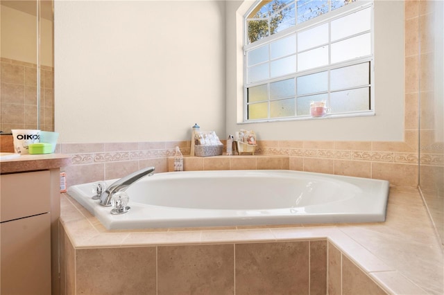 bathroom with vanity and tiled bath