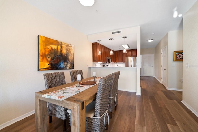 dining space featuring dark wood-type flooring