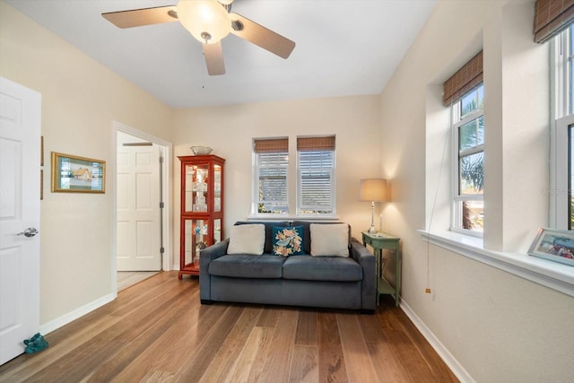 sitting room with hardwood / wood-style floors and ceiling fan