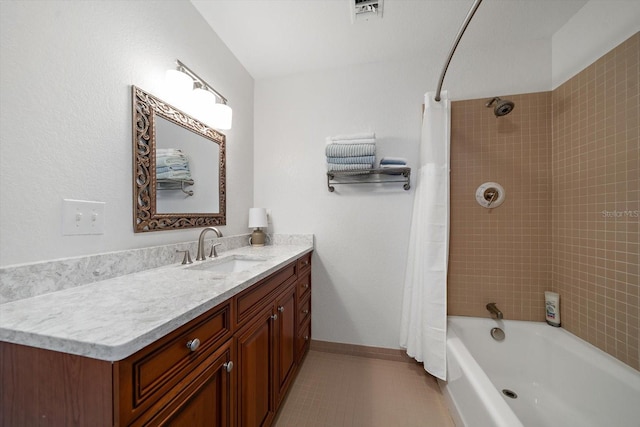 bathroom with vanity, tile patterned floors, and shower / bath combo with shower curtain