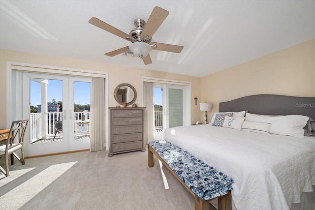 bedroom featuring access to outside, multiple windows, and ceiling fan