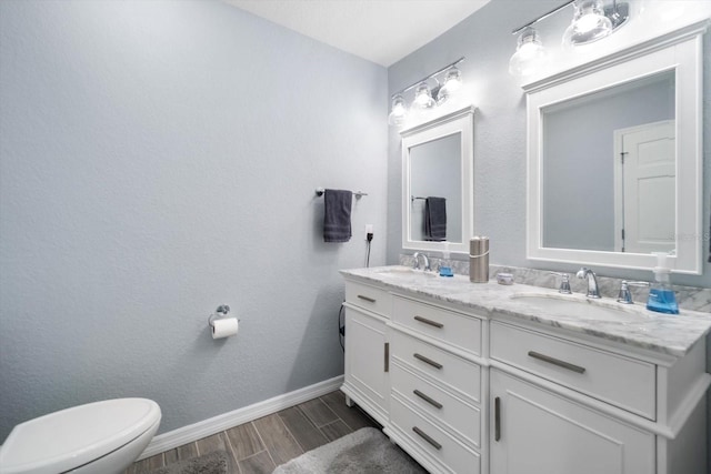 bathroom featuring vanity, toilet, and wood-type flooring