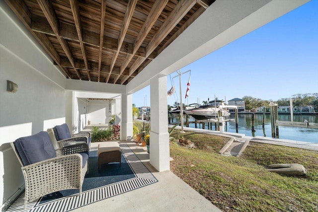 view of patio / terrace with a boat dock and a water view