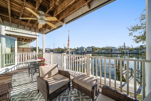 exterior space featuring ceiling fan and a water view