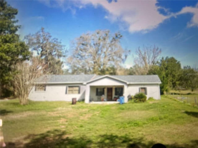 back of property with a lawn