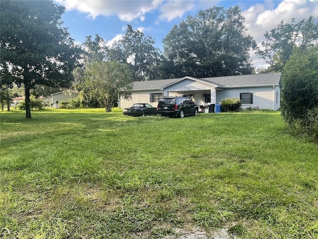 view of front of property with a carport and a front lawn