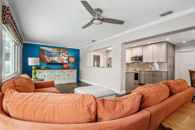 living room with hardwood / wood-style flooring, ceiling fan, and ornamental molding