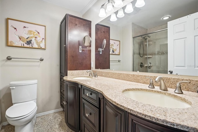 bathroom with vanity, toilet, ornamental molding, and a shower with door