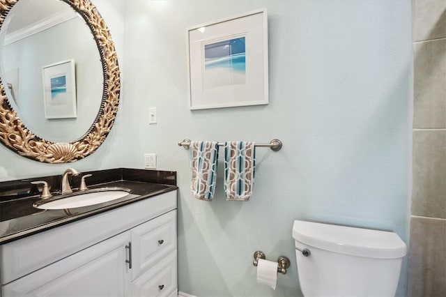 bathroom featuring vanity, toilet, and crown molding