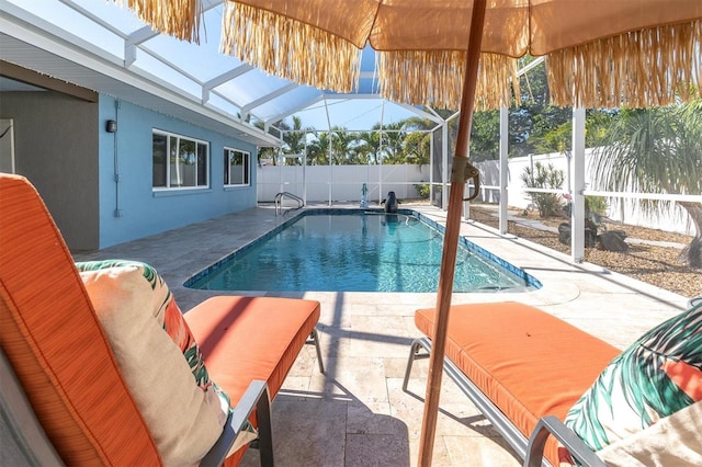 view of pool with a patio and a lanai