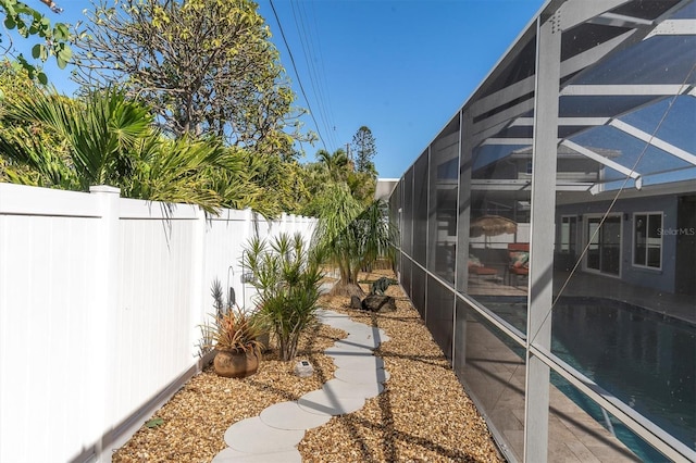 view of yard with a lanai and a fenced in pool