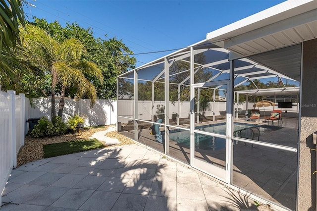 view of patio / terrace with a fenced in pool and glass enclosure