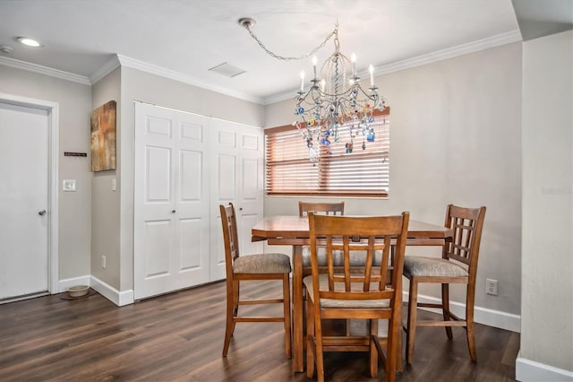 dining room with dark hardwood / wood-style floors, crown molding, and a notable chandelier