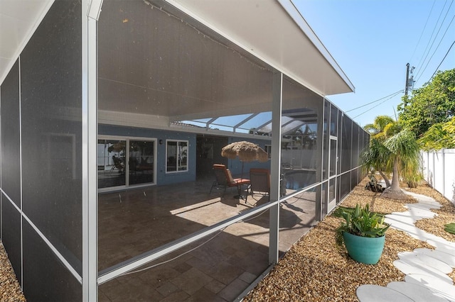 view of patio / terrace featuring a lanai