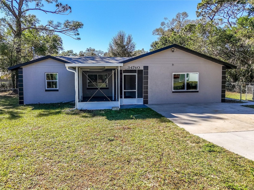 ranch-style house with a front lawn