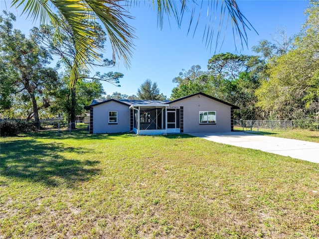 ranch-style house with a sunroom and a front yard