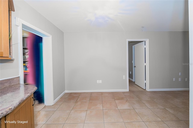 empty room with light tile patterned floors