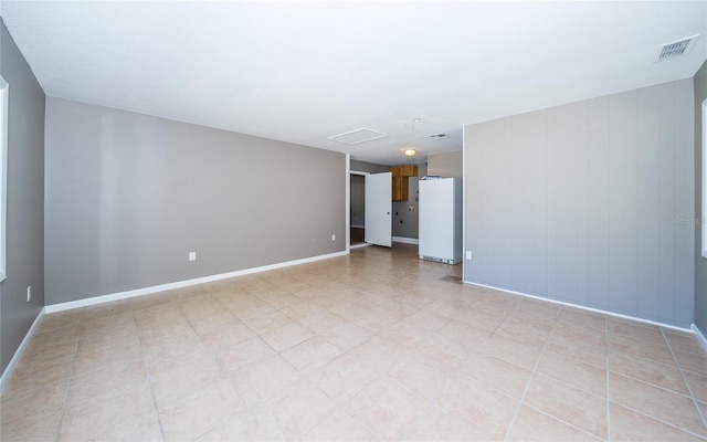 empty room featuring wood walls