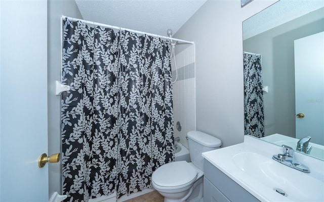 bathroom with vanity, a textured ceiling, and toilet