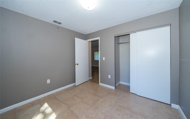 unfurnished bedroom featuring a closet and a textured ceiling