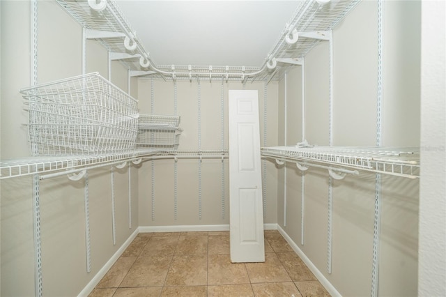 spacious closet featuring light tile patterned floors