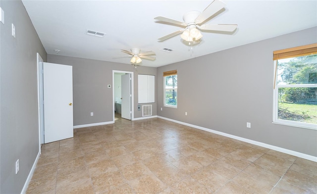 spare room with ceiling fan and a healthy amount of sunlight