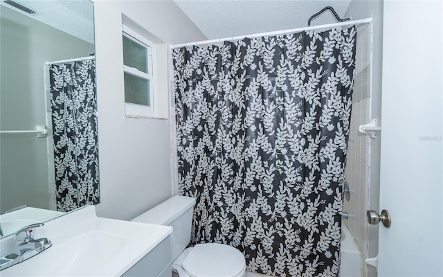 bathroom featuring a shower with shower curtain, vanity, a textured ceiling, and toilet