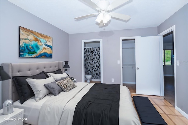 bedroom with a walk in closet, ceiling fan, light hardwood / wood-style flooring, connected bathroom, and a closet