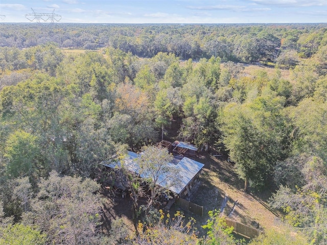 bird's eye view with a wooded view