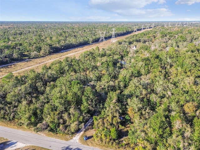 birds eye view of property with a wooded view