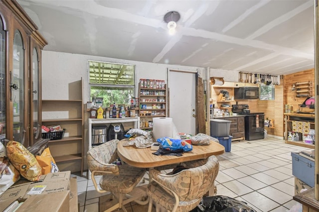 dining room with light tile patterned floors, a workshop area, and wood walls