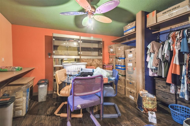 interior space featuring a ceiling fan and dark wood-type flooring