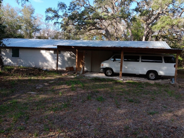 view of parking / parking lot featuring a carport