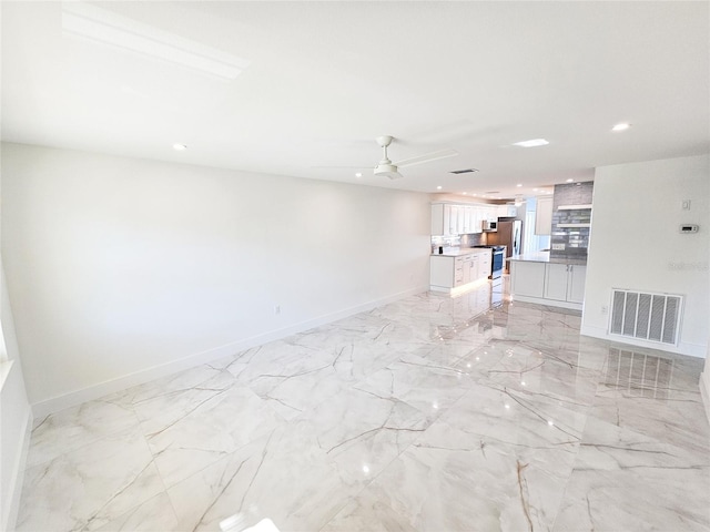 unfurnished living room with ceiling fan