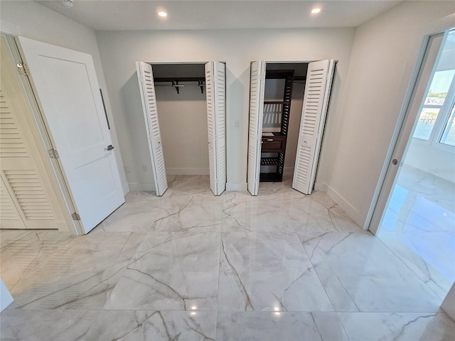 unfurnished bedroom featuring two closets