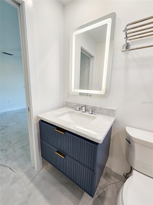 bathroom featuring vanity and toilet