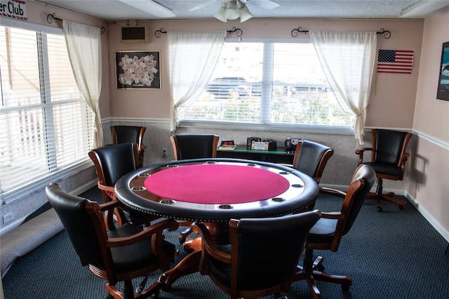 game room featuring carpet flooring, a textured ceiling, and ceiling fan